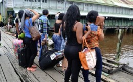 Some of the women waiting on the boat with their luggage.
