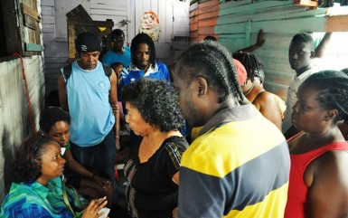 Minister of Social Protection, Volda Lawrence (left) lends a listening ear to residents who turned out to air their concerns. (GINA photo) 