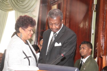 Chief Whip Amna Ally (left) who nominated Dr Barton Scotland as Speaker escorting him to his chair yesterday.