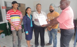 Bharrath Rampersaud (third from right) receiving the certificate (GNBS photo)