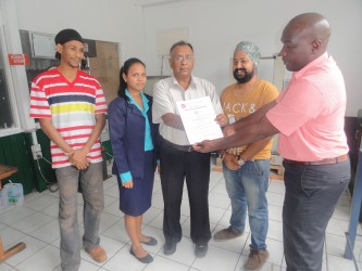 Bharrath Rampersaud (third from right) receiving the certificate (GNBS photo)