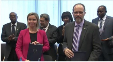 EU High Representative Federica Mogherini and CARIFORUM Secretary General Irwin LaRocque with the agreements after Thursday’s signing.  (EU Delegation photo)