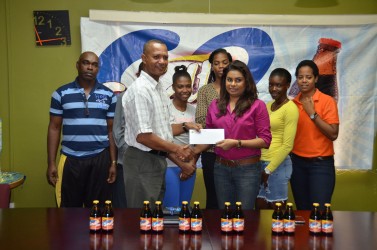 PRO of Ansa McAL, Darshanie Yussuf handing over the sponsorship cheque to president of the AAG, Aubrey Hutson yesterday at the company’s Beterverwagting head office. Yusuf and Hutson are flanked by athletes and Coach, Robert Chisholm.