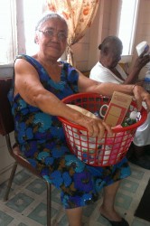  A resident of Chase’s Indigent Home holds her hamper.