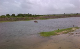 Farmers using a small boat to cross the Hope canal yesterday. 