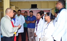 Minister of Public Health, Dr. George Norton (left) interacting with doctors at the Suddie hospital (GINA photo)