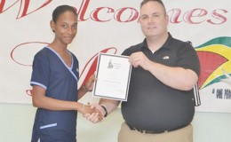 Dan Batsie (right), head of the Atlantic Emergency Medical Service presenting a certificate to one of the participants (GINA photo)
