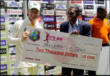 Michael Clarke receives winner’s cheque from Jamaica Cricket Association president Billy Heaven on day four of the second Test between the West Indies and  Australia at Sabina Park, Kingston, Jamaica yesterday.Photo by WICB Media/Randy Brooks of Brooks Latouche Photography 