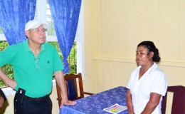 Minister of Public Health, Dr. George Norton (left) interacting with the St. Monica Community Health Worker (CHW) (GINA photo)