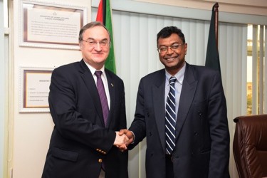 Public Security Minister,  Khemraj Ramjattan (right) greets Nikolay Smirnov, Russian Ambassador to Guyana. (GINA photo)