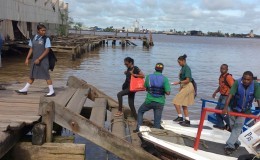 Students and other passengers disembarking a speedboat

