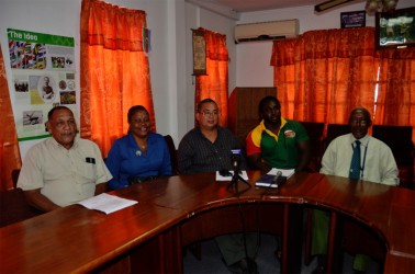 The GRFU top brass and coach of the men’s national rugby team, Theo Henry (second from right) pose for a photo following yesterday’s press briefing at the GOA’s headquarters in Kingston 
