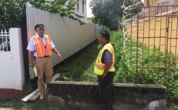 Walter Willis (left) and GAICO Managing Director, Komal Singh standing at one of the alleys on New Market Street between Camp and Thomas streets.
