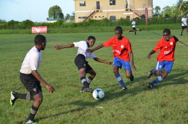 Action between Morgan Learning Centre and Tutorial Secondary at the Ministry of Education ground in the Digicel Secondary School Football Championship 