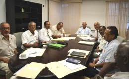 This GINA photo shows the team meeting with Agriculture Minister Noel Holder (at head of table) 