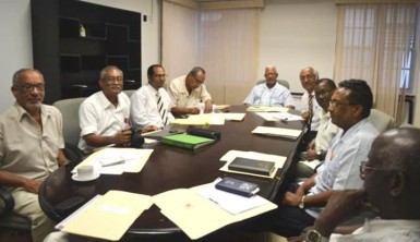 This GINA photo shows the team meeting with Agriculture Minister Noel Holder (at head of table) 