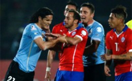 Uruguayan player Edinson Cavani clashes with Chile players following the ‘finger’ incident
