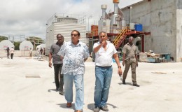 Prime Minister Moses Nagamootoo (left) being shown around the Giftland Mall site by its President Roy Beepat. Behind them is the mall’s power plant.