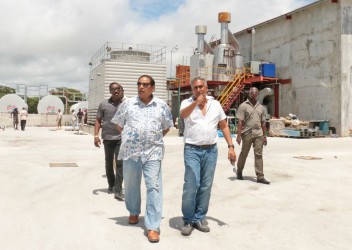 Prime Minister Moses Nagamootoo (left) being shown around the Giftland Mall site by its President Roy Beepat. Behind them is the mall’s power plant. 