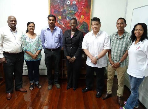 Minister Nicolette Henry flanked by members of the Guyana Karate College during the recent courtesy call on the minster. 