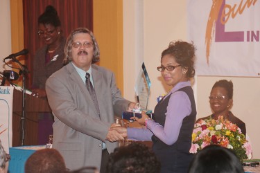 Cassandra Sunthgolam being presented with one of her awards by Managing Director of RBL John Alves.  