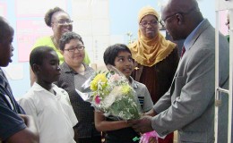 Chief Education Officer Olato Sam with the top performer of St Gabriel’s Primary School. (Ministry of Education photo)