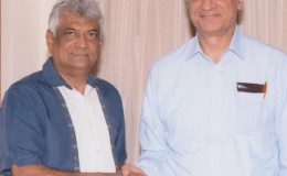 Dr Steve Surujbally (left) and Kamalesh Sharma on Sunday (GECOM photo)
