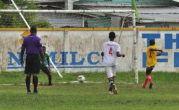 New Campbellville Secondary’s Trevon Pluck (yellow) converting his penalty attempt into the lower left hand corner during his team’s lopsided win over Sophia Training Centre at the Tucville Community ground