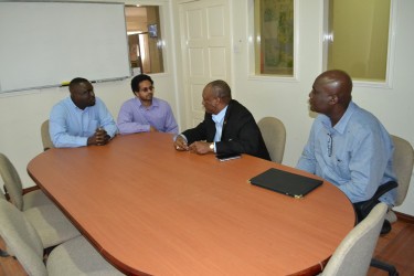 Project Manager of the controversial E-Governance Project Alexei Ramotar (second from left) in talks with Minister of State Joseph Harmon yesterday. (Ministry of the Presidency photo)