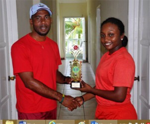 MVP Plaffiana Millington  collects her prize from coach of the Berbice team Andre Percival. 