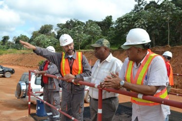 Minister of Governance, Raphael Trotman (right) and Member of Parliament for Region Ten, Audwin Rutherford (second from right) being briefed by a RUSAL official on the company’s operations (GINA photo) 