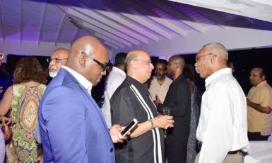 President David Granger (right) speaking with Sir Ronald Sanders, Senior Research Fellow at the Institute of Commonwealth Studies  and others during the reception. (GINA photo)