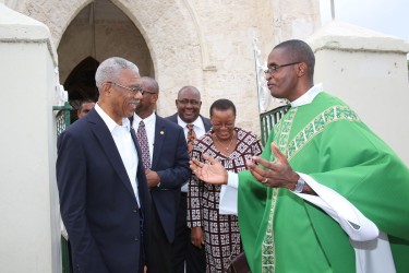 Rev Hugh Sandiford of St Matthias Anglican Church (right) greets President David Granger who went there for mass on Sunday morning prior to the breakfast meeting. Also in photo are Barbados’ Foreign Minister Senator Maxine McClean and Guyana’s consul in Barbados Michael Brotherson (Photo by Nigel Browne) 