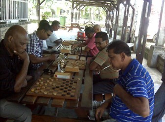  Action between Draughts players from Suriname and Guyana during the recent Goodwill Series played in Nickerie, Suriname over the weekend .