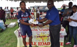 Geron Williams receiving his trophy and first place prize from Finance Controller of NAMILCO, Fitzroy McLeod on Monday at the Seawall Bandstand. 