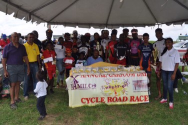 Monday’s prize winners of the 12th annual CARICOM Day Wheat Up Classic pose with their spoils. They are flanked by the top brass of NAMILCO and the Roraima Bikers Club. 