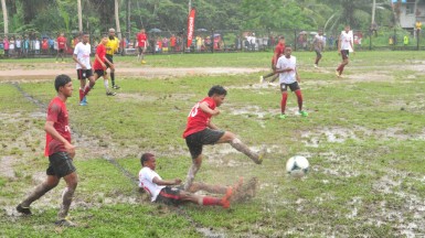 Ishmael Glen of Port Kaituma (centre) in the process of winning the ball against Santa Rosa’s Lexter Fredericks via a fair crunching tackle during their team’s hard-fought Region #1 Divisional Finale at the Kumaka ground in Moruca. 