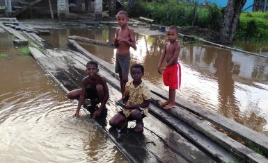 Young boys playing by the trench
