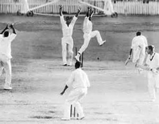 The West Indies players celebrate as Joe Solomon’s throw breaks the stumps to record the first tied test match in cricket history during the 1960 tour of Australia. 