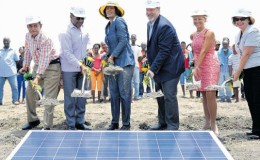 Prime Minister Portia Simpson Miller (third left) breaks ground for the development of the first utility-scale solar energy power plant in Jamaica. Joining the Prime Minister are (from left) Member of Parliament and Minister of Local Government and Community Development Noel Arscott; Minister of Science Technology, Energy and Mining Phillip Paulwell, CEO WRB Energy Inc and Content Solar Ltd, Robert Blenker; President and CEO Jamaica Public Service Kelly Tomlin; and Chargé d’ affaires at the US Embassy Elizabeth Martinez.  
