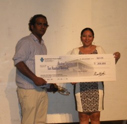  Rustom Seegopaul (left) receives his cheque from Dr Paloma Mohamed 
