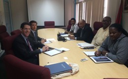 The Anadarko delegation (left) meeting with the government delegation. Minister of Governance Raphael Trotman is third from right. (Ministry of the Presidency photo)