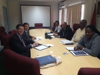 The Anadarko delegation (left) meeting with the government delegation. Minister of Governance Raphael Trotman is third from right. (Ministry of the Presidency photo)