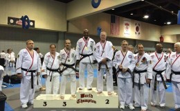 World Martial Arts champion Professor Ken Danns flanked by the second and third placed finishers on the podium at the recent Martial Arts tournament in the USA.