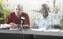 Vice-President Michael Singh (left) addressing the gathering at the Duke Lodge during the announcement of the Inter-Guiana Games Boys and Girls u-19 Squads while Manger of the IGG Basketball teams Cecil Chin looks on