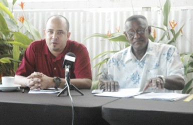 Vice-President Michael Singh (left) addressing the gathering at the Duke Lodge during the announcement of the Inter-Guiana Games Boys and Girls u-19 Squads while Manger of the IGG Basketball teams Cecil Chin looks on 