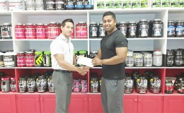 Organizing Secretary of the GABBFF, Videsh Sookram (right) receiving the sponsorship cheque from Fitness Express’ CEO, Jamie McDonald on Thursday at the company’s 47 John and Sheriff Streets location.
