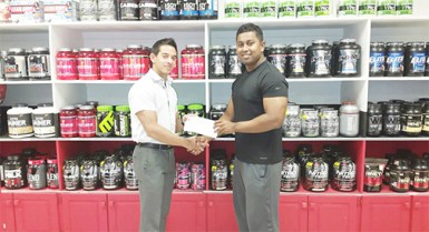 Organizing Secretary of the GABBFF, Videsh Sookram (right) receiving the sponsorship cheque from Fitness Express’ CEO, Jamie McDonald on Thursday at the company’s 47 John and Sheriff Streets location. 