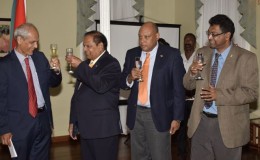First Vice-President and Prime Minister Moses Nagamootoo (second from left) and France’s Ambassador to Guyana Michel Prom share a toast at the France’s National Day commemoration at Cara Lodge. From right are Public Security Minister Khemraj Ramjattan and Minister of Governance, Raphael Trotman. (GINA photo)