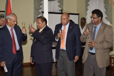 First Vice-President and Prime Minister Moses Nagamootoo (second from left) and France’s Ambassador to Guyana Michel Prom share a toast at the France’s National Day commemoration at Cara Lodge. From right are Public Security Minister Khemraj Ramjattan and Minister of Governance, Raphael Trotman. (GINA photo)  